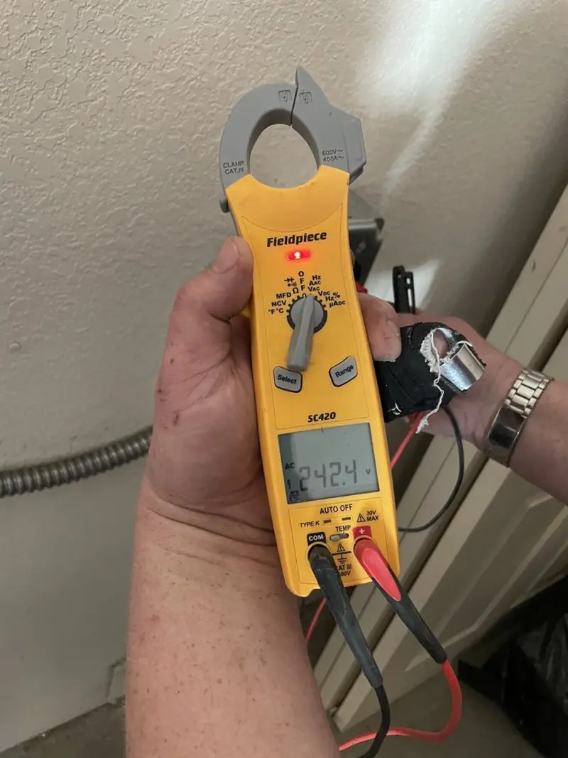 Voltage testing with clamp meter during Ceiling Fan Installation in North Madison